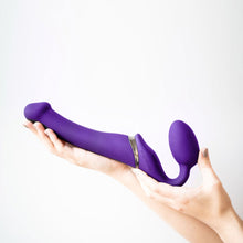 Charger l'image dans la galerie, Main manucurée tenant le vibrateur double ajustable mauve de Strap-On-Me sur fond blanc